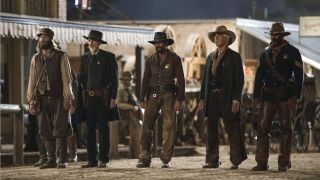 james dutton and other cowboys standing in a line in 1883