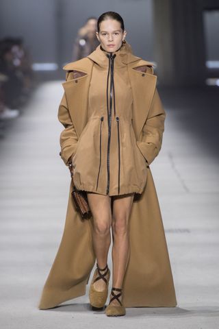 Woman on runway in tod’s long overcoat