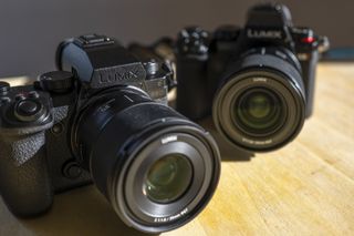 Panasonic S5 IIX camera on a table in front of the Panasonic S5 II camera