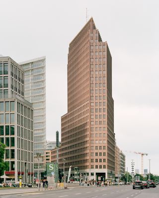 walking through Potsdamer Platz in Berlin and its postmodernist architecture, showing large scale buildings with transparencies and grids