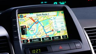 Image of the display screen of an in car navigation system showing a map and a "quickest route".