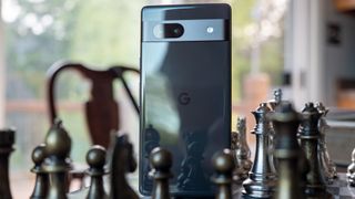 The back of the black Google Pixel 7a on a chess board