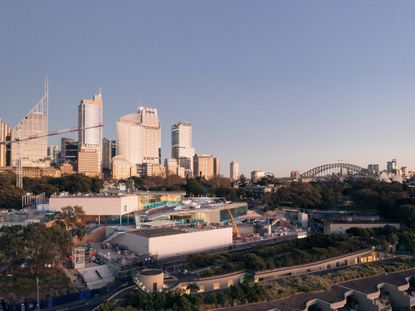 a view of sydney city skyline over gallery nsw, bridge in distance