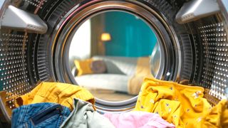 Inside a washing machine with yellow clothes inside