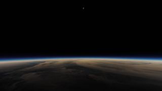 Totality and shadow of the moon in the top center portion of the image, Earth and the hazy blue glow of the atmosphere is seen below. 