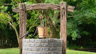 A well and wooden bucket