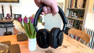 Bowers & Wilkins Px7 S2e held in hand above a dining table