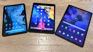 The Nokia T20, iPad and Samsung Galaxy Tab S7 FE, lying display up on a wooden floor