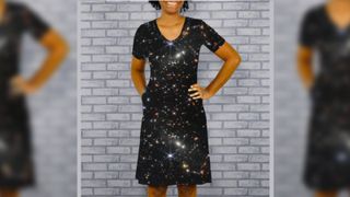 Woman wearing a dress with a design depicting a james web space telescope photograph