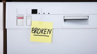 A dishwasher with a broken sticky label on front