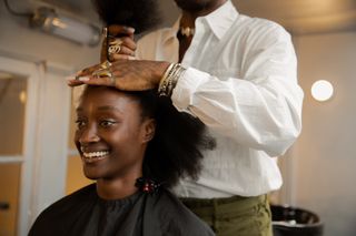 Hairstylist Issac Polen working on a clients hair during his Browns London residency