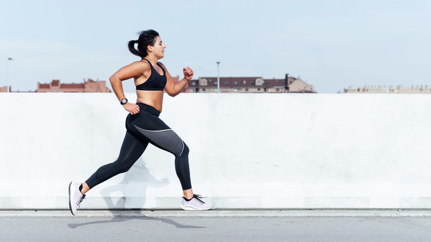 Woman sprinting outside in an urban area