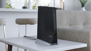 Netgear Nighthawk AX8 WiFi Mesh Extender (EAX80) on table in living room