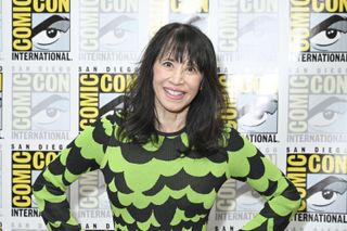 actors smile for portraits in from of a banner that reads "comic con international"