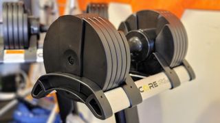 Core Home Fitness Adjustable Dumbbell on a storage rack