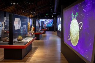 view of the inside of a space museum, with several exhibits encased in glass