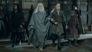 From left to right: Aragorn, Gandalf, Legolas and Gimli walking into a castle in Two Towers.