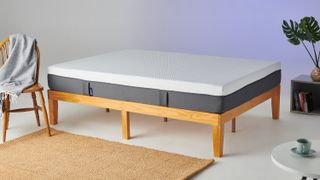 The Emma Original mattress shown on a light wooden bed frame