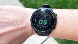 Garmin Forerunner 55 on a person's wrist showing the time