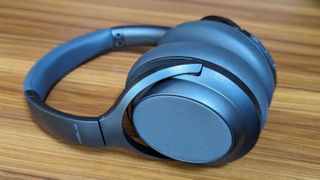 Treblab Z7 Pro wireless headphones on a wooden table.