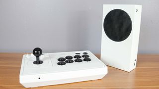 The 8BitDo Arcade Stick for Xbox next to an Xbox Series S