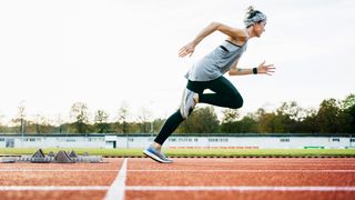 a photo of a woman running on a track