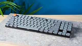 A black Keychron K13 Max wireless keyboard with gray and orange keycaps