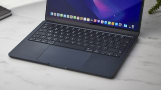 Apple MacBook Air (M2, 2022) on a white desk in a studio