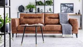 A brown leather couch in a living room