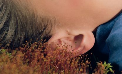 child sleep on grass