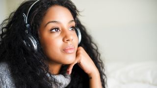 Young woman with headphones after using a CD ripper