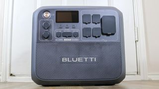 The Bluetti AC200L portable power station in front of a door