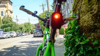 The Trek CarBack bike radar shown mounted on the seatpost of a green bike.