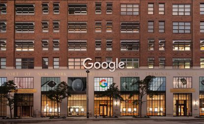 The façade of the Google New York store, featuring a brick facade and high windows facing the street. Google&#039;s logo is visible above the door