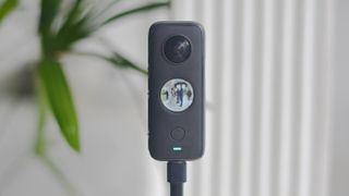 An Insta360 One X2 camera mounted on a tripod