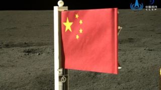 closeup of china's red, five-star national flag on the surface of the moon.