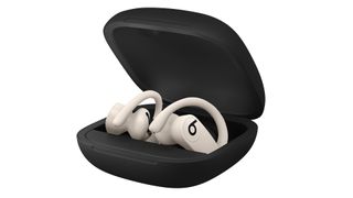 A white pair of Beats Powerbeats Pro in their charging case.