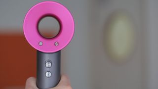 The Dyson Supersonic hair dryer being held upright