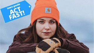 Women wearing a Carhartt Knit Beanie in orange.