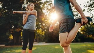 a couple stretching after a run