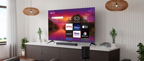 Roku Plus Series 4K QLED TV on tv stand