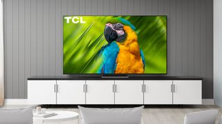 The 2022 TCL R655 hanging on a wall in a living room.