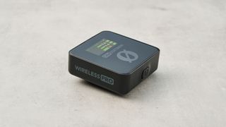 The Rode Wireless Pro microphone lying down on a stone surface