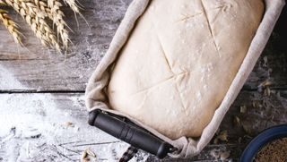 Homemade bread in tin proving