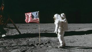 NASA astronaut Edwin (Buzz) Aldrin Jr stands beside the United States flag during Apollo 11 during a moon walk. 