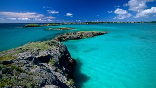 Stunning blue view of the sea along a shallow rocky coast