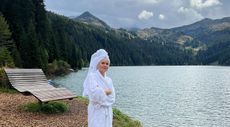 Dr Barbara Sturm wearing a white towel and robe in the Gstaad mountains