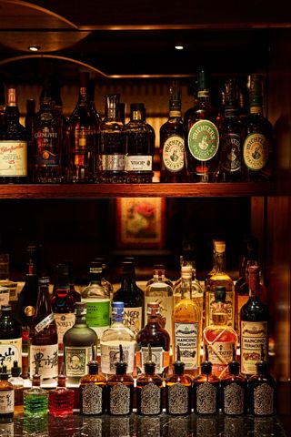 Bottles of alcohol and bitters at The Omakase Bar cocktail experience at The Aubrey, London