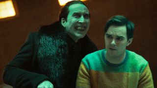 Nicolas Cage smiles as he looms over a worried Nicholas Hoult in Renfield.