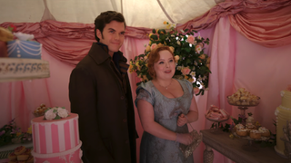 Colin Bridgerton and Penelope Featherington standing in a sweet shop in Season 3, Episode 3